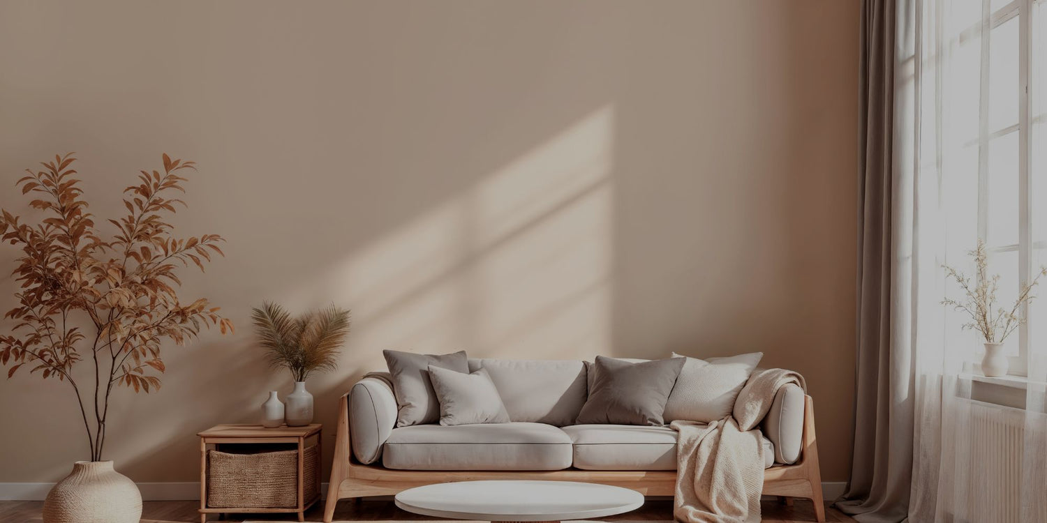 Cozy living room with a beige sofa, wooden coffee table, and decorative plants.