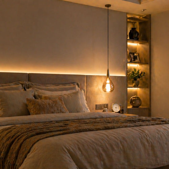 Neatly made bed with pillows and a blanket in a bedroom setting.